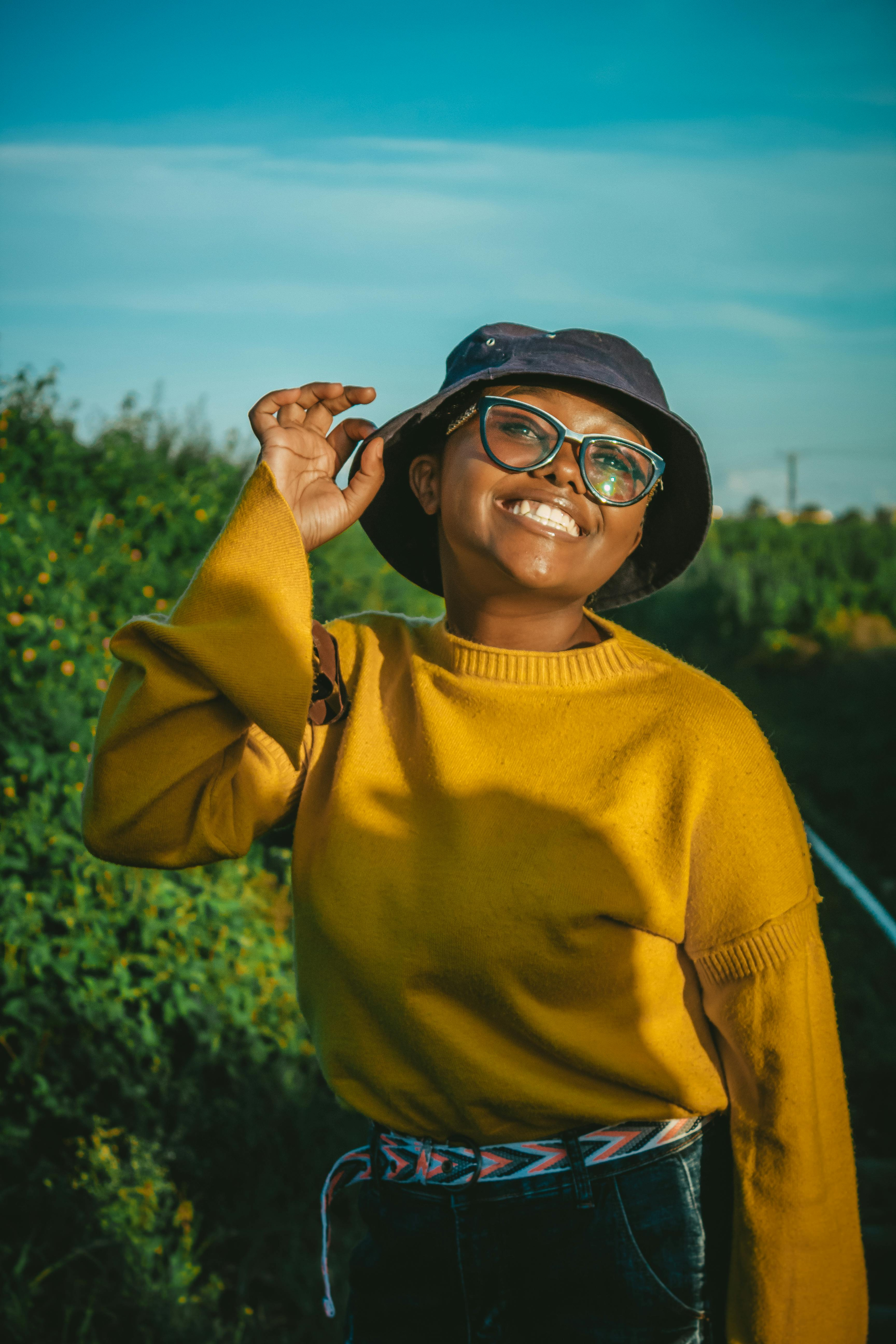 Client in a yellow jumper smiling outdoors